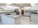 Spacious kitchen boasts granite countertops and modern stainless steel appliances at 26800 Racquet Cir, Leesburg, FL 34748