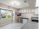 Bright kitchen featuring a sleek desk area and a window with a pleasant outdoor view at 26800 Racquet Cir, Leesburg, FL 34748