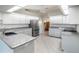 Large kitchen featuring granite countertops, modern appliances, and ample storage at 26800 Racquet Cir, Leesburg, FL 34748