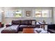 Cozy living room features a comfortable leather sectional sofa and bright windows at 26800 Racquet Cir, Leesburg, FL 34748