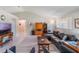 Comfortable living room with vaulted ceiling, laminate flooring, and an open layout at 26800 Racquet Cir, Leesburg, FL 34748