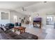 Open floor plan featuring living room, dining area, and view into the kitchen with a vaulted ceiling at 26800 Racquet Cir, Leesburg, FL 34748
