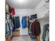 Walk-in closet featuring ample storage space with shelves and racks at 26800 Racquet Cir, Leesburg, FL 34748