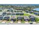 An aerial view of a community with two-story homes, featuring manicured lawns and mature trees at 3054 Hill Point St, Minneola, FL 34715
