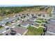 An aerial view of a community with two-story homes, manicured lawns, trees, and nearby pond at 3054 Hill Point St, Minneola, FL 34715
