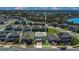 Aerial view of a neighborhood featuring many two-story homes with well-maintained lawns near a lake at 3054 Hill Point St, Minneola, FL 34715