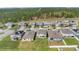 Beautiful aerial view of a neighborhood with manicured lawns and various home styles amid lush greenery at 3054 Hill Point St, Minneola, FL 34715