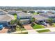 Aerial view of a two-story home featuring a brick driveway, well-maintained lawn, and lush landscaping at 3054 Hill Point St, Minneola, FL 34715
