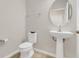 Powder room featuring a pedestal sink, oval mirror, and tiled flooring at 3054 Hill Point St, Minneola, FL 34715