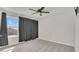 Bedroom with neutral carpet, gray walls, large windows and a fan at 3054 Hill Point St, Minneola, FL 34715