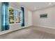 Bright bedroom featuring plush carpeting, a window with sheer curtains, and neutral wall paint at 3054 Hill Point St, Minneola, FL 34715