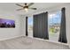 Bright bedroom with a ceiling fan, gray walls, large windows and gray curtains at 3054 Hill Point St, Minneola, FL 34715