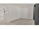 A bedroom with neutral carpeting and gray walls next to the stairway at 3054 Hill Point St, Minneola, FL 34715