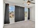 Large bedroom featuring two windows and neutral colored carpet at 3054 Hill Point St, Minneola, FL 34715