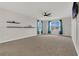 Large bonus room with large windows, a ceiling fan, and decorative shelving at 3054 Hill Point St, Minneola, FL 34715