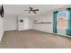Carpeted bonus room featuring a ceiling fan, shelving, and window with sheer curtains at 3054 Hill Point St, Minneola, FL 34715