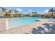 Large community pool area with lounge chairs and well manicured landscaping on a sunny day at 3054 Hill Point St, Minneola, FL 34715