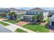 Two-story home featuring a brick driveway, well-maintained lawn, and lush landscaping at 3054 Hill Point St, Minneola, FL 34715