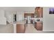 Modern kitchen featuring stainless steel appliances and granite countertops at 3054 Hill Point St, Minneola, FL 34715