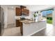 Modern kitchen with stainless steel appliances, granite countertops, and a breakfast bar at 3054 Hill Point St, Minneola, FL 34715