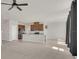 Bright open-concept kitchen and living area with lots of natural light and granite countertops at 3054 Hill Point St, Minneola, FL 34715