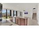 Open-concept kitchen with a large island, granite countertops, and stainless steel appliances at 3054 Hill Point St, Minneola, FL 34715