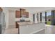 Modern kitchen featuring granite countertops, stainless steel appliances, and a kitchen island with sink at 3054 Hill Point St, Minneola, FL 34715