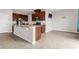 Modern kitchen with granite countertops, stainless steel appliances, and tiled flooring at 3054 Hill Point St, Minneola, FL 34715