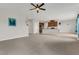Spacious living room seamlessly connecting to the kitchen, featuring plush carpeting and modern paint at 3054 Hill Point St, Minneola, FL 34715