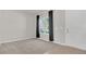 An empty living room with neutral carpet, gray walls and a window at 3054 Hill Point St, Minneola, FL 34715