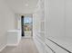 Spacious walk-in closet with custom white shelving and drawers, and a window at 3054 Hill Point St, Minneola, FL 34715