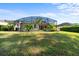 Backyard view showcasing a screened lanai and lush greenery, perfect for outdoor relaxation at 306 Orista Dr, Davenport, FL 33897
