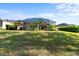 Backyard view showcasing a screened lanai and lush greenery, perfect for outdoor relaxation at 306 Orista Dr, Davenport, FL 33897
