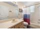 Bright bathroom with single sink vanity, bathtub with shower, and a window for natural light at 306 Orista Dr, Davenport, FL 33897