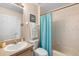A cozy bathroom featuring a vanity, toilet, and shower with tub at 306 Orista Dr, Davenport, FL 33897