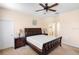 Bedroom features a ceiling fan, neutral paint, and a large window for natural light at 306 Orista Dr, Davenport, FL 33897