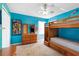 A blue bedroom with a bunk bed, a ceiling fan and carpeted floors at 306 Orista Dr, Davenport, FL 33897