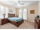 A bright bedroom featuring a wood bed frame, soft carpet, and light-colored walls at 306 Orista Dr, Davenport, FL 33897