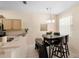 Open dining area features a modern pendant light and a breakfast bar at 306 Orista Dr, Davenport, FL 33897