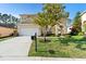 Charming two-story home showcasing a well-manicured lawn and beautiful landscaping at 306 Orista Dr, Davenport, FL 33897
