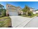 Charming two-story home showcasing a well-manicured lawn and beautiful landscaping at 306 Orista Dr, Davenport, FL 33897