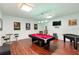 Spacious game room with a pool table, foosball, stylish lighting and sleek wooden flooring at 306 Orista Dr, Davenport, FL 33897