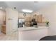 Well-lit kitchen features stainless steel appliances and ample cabinet space at 306 Orista Dr, Davenport, FL 33897