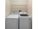 Functional laundry area featuring a washer and dryer with wire shelving above at 306 Orista Dr, Davenport, FL 33897