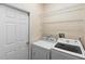 Bright laundry room with Samsung washer/dryer and wire shelving for convenient storage at 306 Orista Dr, Davenport, FL 33897