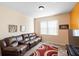Cozy living room features a plush sofa, large window, and wood flooring at 306 Orista Dr, Davenport, FL 33897