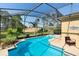 The backyard features a sparkling pool and a large, screened-in patio at 306 Orista Dr, Davenport, FL 33897