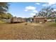 Large backyard with above ground pool, deck, storage building, and mature trees at 33311 Green Rd, Leesburg, FL 34788