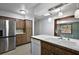 Charming kitchen featuring wood cabinets, stainless steel refrigerator, and a double basin sink at 33311 Green Rd, Leesburg, FL 34788