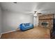 Cozy living room featuring a brick fireplace, light colored walls, and ceiling fan at 33311 Green Rd, Leesburg, FL 34788